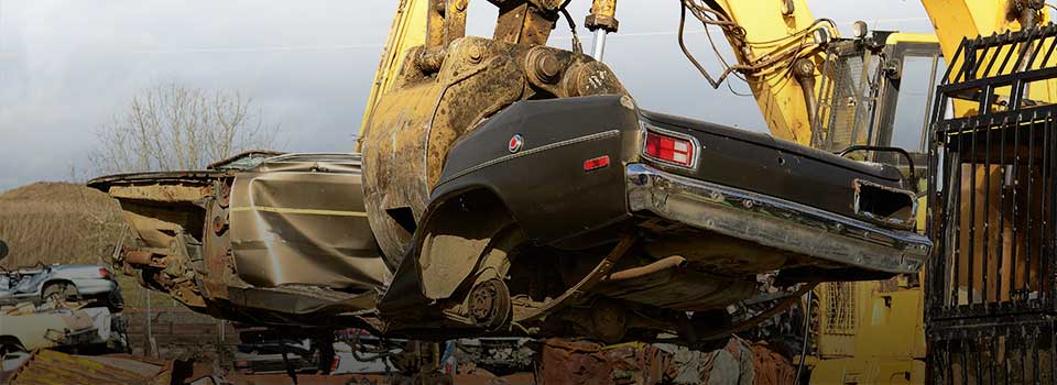Car at Scrap Yard with headline: $54.6 million in state and local taxes.